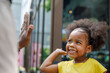 © Jovo Jovanovic/Stocksy - Little black girl gives high five as she smiles