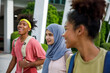 © Jovo Jovanovic/Stocksy - Group of student friends, two girls and one boy having fun outdoors