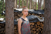 Portrait Of A Teen Girl By A Woodpile