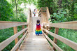 © Anya Brewley Schultheiss/Stocksy - Child in rainbow dress walking down a long flight of wooden stairs