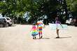 © Anya Brewley Schultheiss/Stocksy - Children in colourful dresses walking to the beach.