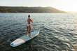© Marko/Stocksy - Woman on SUP paddle board