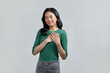 © Marc Tran/Stocksy - Happy mindful thankful young woman holding hands on chest smiling