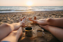 Crop Legs Of Man And Woman Lying On Beach With Drinks