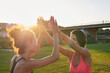 © Guille Faingold/Stocksy - Female athletes doing high five