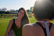 © Guille Faingold/Stocksy - Happy sportswoman talking with friend in park