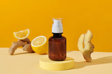 Bottles With Ginger Essential Oil On Light Background
