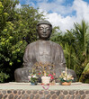 Meditate with the Giant Buddha statue with flowers in bliss at the Jodo Mission off Front Street in Lahaina, Maui, Hawaii