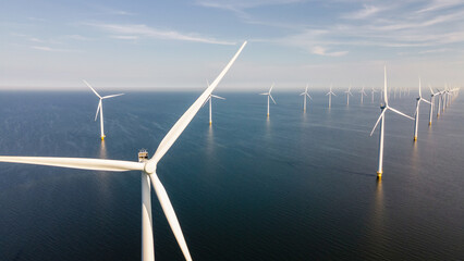 Windmill park with clouds and a blue sky, windmill park in the ocean aerial view with wind turbine Flevoland Netherlands Ijsselmeer. Green energy production in the Netherlands