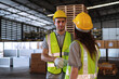 © Nunkung - Industrial male engineer shake hands with colleague female congratulating on successful factory warehouse management.