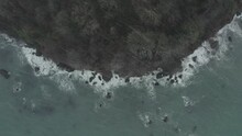 Drone Shot Of Rugged Coastline With Rain And Snow