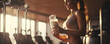 Healthy young woman is preparing protein shake after training in the gym. Fitness and healthy lifestyle.