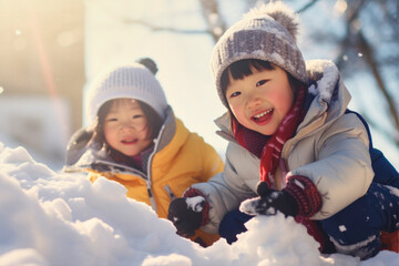 asian kids having fun and playing in the snow