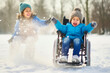 © the_lightwriter - kid in wheelchair playing in the snow