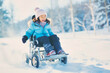 © the_lightwriter - kid in wheelchair playing in the snow