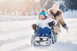 © the_lightwriter - kid in wheelchair playing in the snow