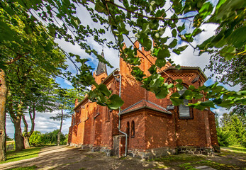 Wall Mural - General view and close-up architectural details of the Catholic Church of St. Holy Trinity in the town of Dwawrzuty in Masuria in Poland.