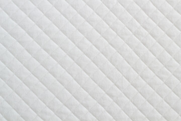 Blue quilted fabric. The texture of the blanket	