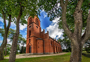 Wall Mural - General view and close-up architectural details of the Catholic Church of St. Holy Trinity in the town of Dwawrzuty in Masuria in Poland.