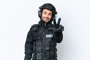 Wall Mural - Young caucasian SWAT man isolated on white background smiling and showing victory sign