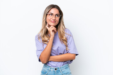 Wall Mural - Young Uruguayan woman isolated on white background thinking an idea while looking up