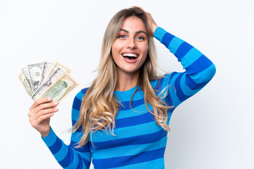 Canvas Print - Young Uruguayan woman taking a lot of money isolated on white background with surprise expression