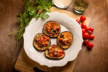 Wall Mural - oven grated eggplants with fresh tomatoes and cheese