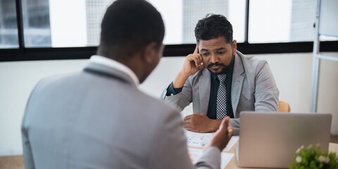 Business people indian and african american worker looking discussing corporate strategy in teamwork, working on computer laptop in office at office