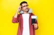 Leinwandbild Motiv Young handsome man with Inflatable Travel Pillow over isolated yellow background having doubts and thinking