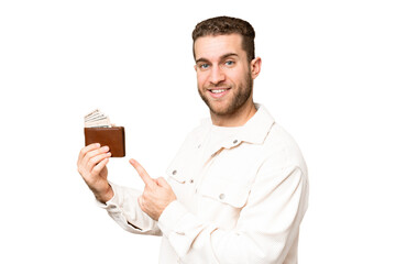 Wall Mural - Young handsome blonde man holding a wallet over isolated chroma key background and pointing it