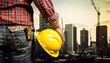 Construction worker with safety helmet on construction site background. Engineering and architecture concept.