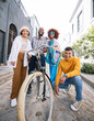 © Wesley/peopleimages.com - Friends group, bicycle and happy outdoor for travel, fashion style and fun with youth in the city. Diversity, gen z and men and women portrait to relax, student adventure or freedom on urban street