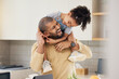 © Wesley/peopleimages.com - Happy family, hug and father and girl child in a kitchen with piggyback, games and fun, breakfast and laugh at home. Love, smile and parent with kid embrace, playful and bonding in a house on weekend