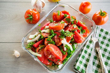 Sticker - Spicy snack tomatoes with garlic, herbs, seasonings and onions in a glass bowl .