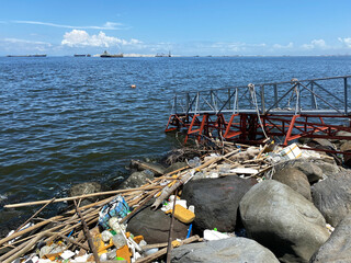 Long stretch of Beach, sea shore littered with ocean debris washed on the shore.