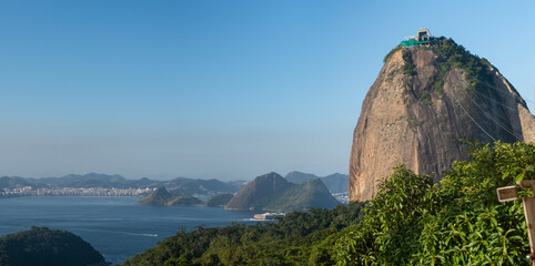 Wall Mural - Rio de Janeiro, Brazil: the Sugarloaf Mountain and Cable Car with panoramic view of the skyline of the municipality of Niteroi seen from Morro da Urca (Urca Mountain)