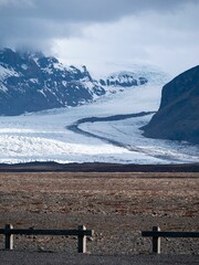 Sticker - Majestic snow-capped mountain stands alone in the middle of a peaceful wintery field