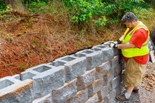 Securin Concrete Block To Retaining Wall Was An Essential Of Construction Process.