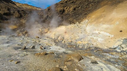 Canvas Print - Closeup of Multicolored soil of the Seltun geothermal field on a sunny day