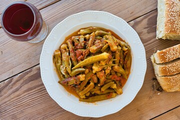 Canvas Print - traditional Greek food for the summer, okra in a pot, with fresh tomatoes, on a plate