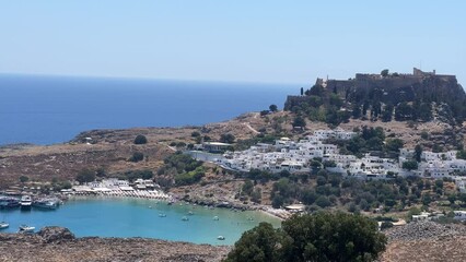 Canvas Print - Beautiful view of the Lindos Acropolis by the sea in Lindos, Greece under blue sky