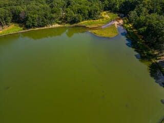 Sticker - Aerial top down view over a park with a green pond on a sunny day on Long Island, NY