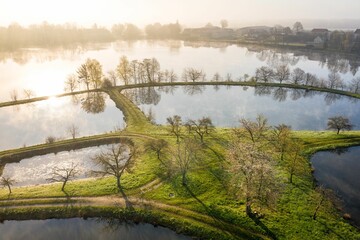 Sticker - Aerial shot of a tranquil body of water  surrounded by lush greenery