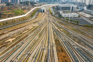 Sticker - Aerial shot of a bustling cityscape featuring multiple railroads and train tracks