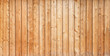 Texture of the pale orange wall made of knotty sanded wooden boards as a retro natural background