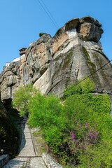 Poster - rock formations in the distance with a path that goes to a large rock formation