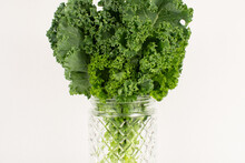 Bright Green Kale Leaves In Decorative Glass Jar