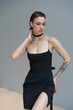 © Igor - young beautiful woman posing in a black short dress in the studio