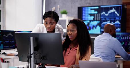 Canvas Print - African Financial Data Analysts Using Dashboard On Screens