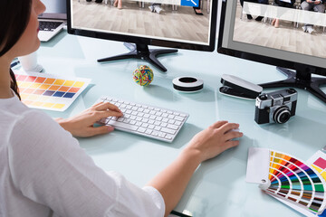 Wall Mural - Female Designer Working On Multiple Computer